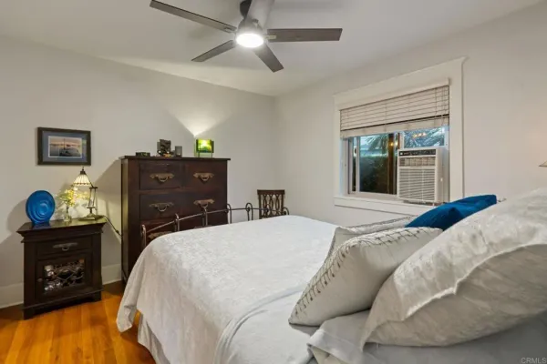 a spacious bedroom with a bed and a dresser