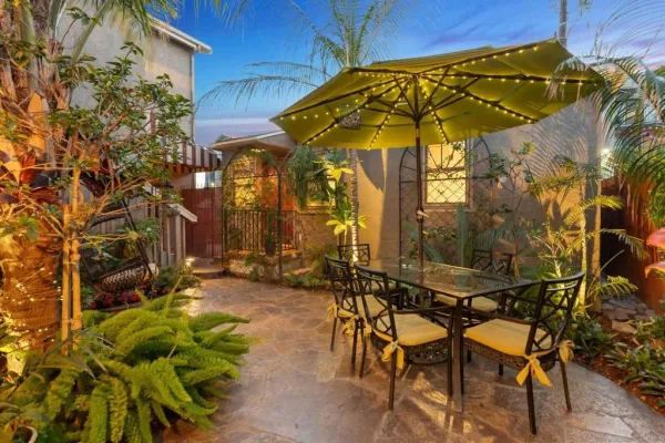a kitchen with stainless steel appliances kitchen island granite countertop a refrigerator and a stove top oven