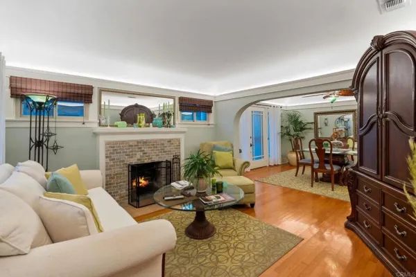 a view of a dining room with furniture and a chandelier