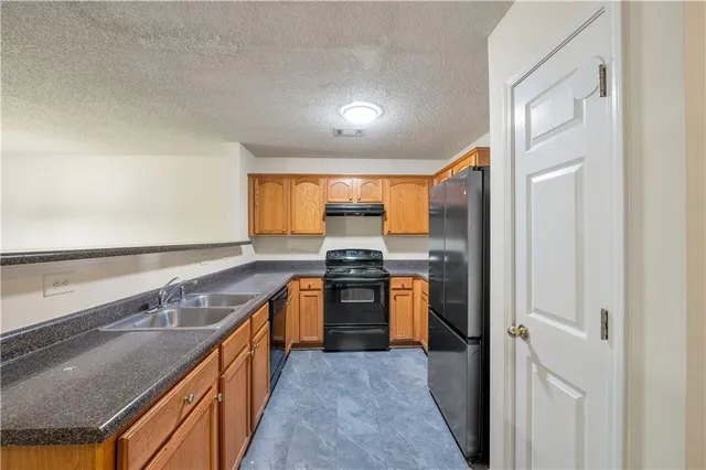 a kitchen with stainless steel appliances granite countertop a stove and a sink