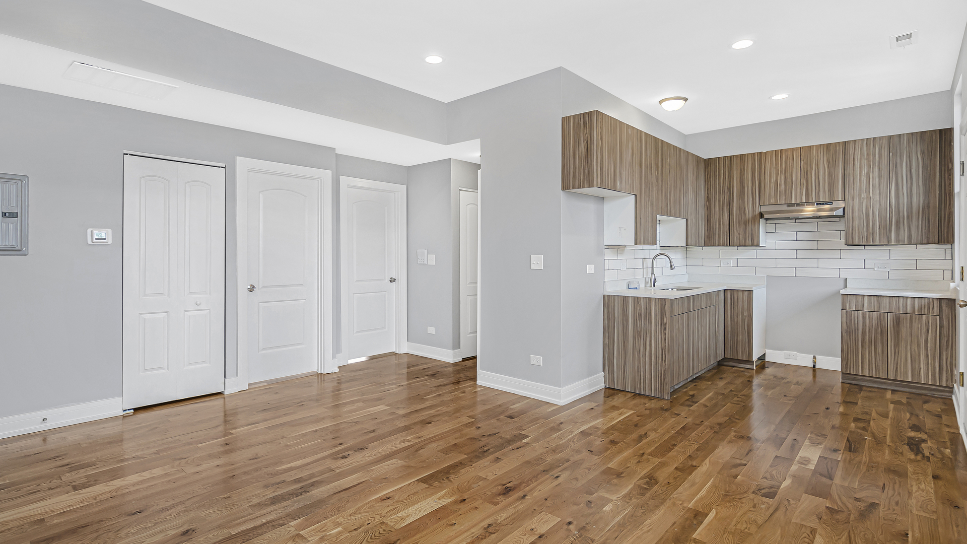 342 East 50th Street, Unit 1 Chicago, IL 60615 - Photo 4 of 16 a view of a kitchen with wooden floor and electronic appliances