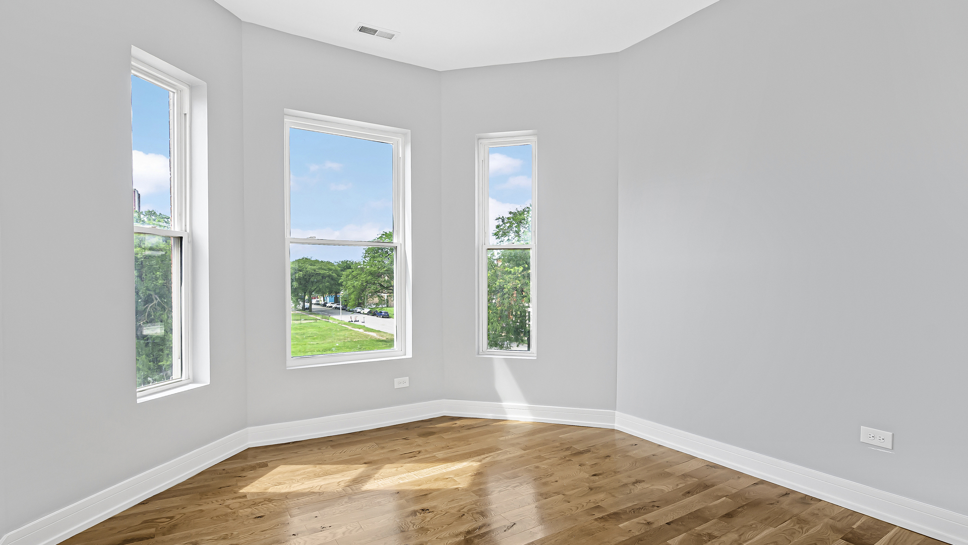 342 East 50th Street, Unit 1 Chicago, IL 60615 - Photo 8 of 16 a view of an empty room with wooden floor and a window