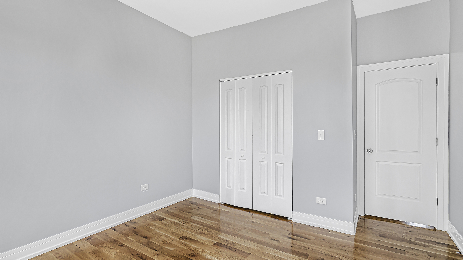 342 East 50th Street, Unit 1 Chicago, IL 60615 - Photo 9 of 16 a view of an empty room with wooden floor