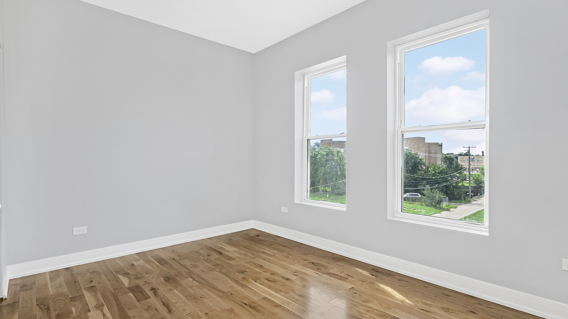 342 East 50th Street, Unit 1 Chicago, IL 60615 - Photo 10 of 16 an empty room with wooden floor and windows