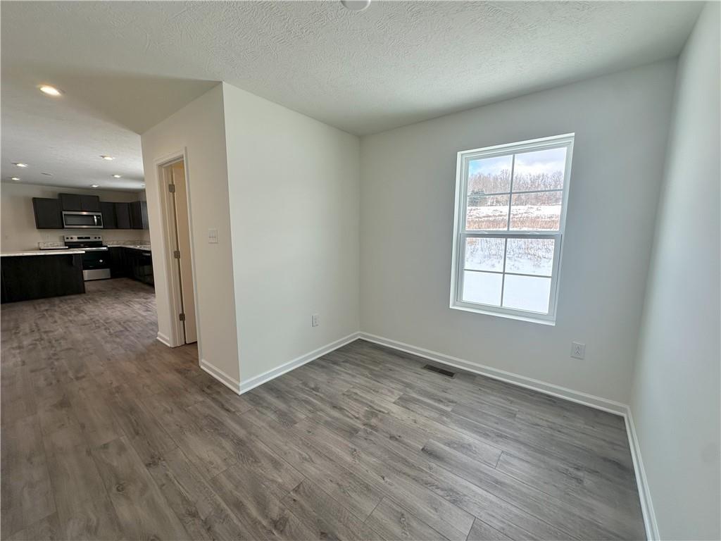 121 Marginal Road Hunker, PA 15639 - Photo 12 of 34 an empty room with wooden floor and windows