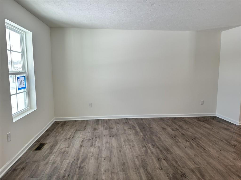 121 Marginal Road Hunker, PA 15639 - Photo 6 of 34 an empty room with wooden floor and windows