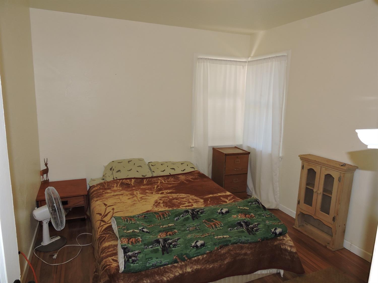 7233 Wagner Creek Road Talent, OR 97540 - Photo 21 of 27 a bedroom with a bed and a table in it
