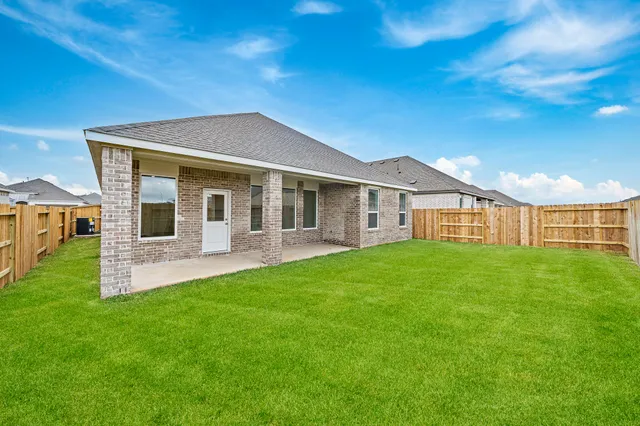a view of a house with a yard and porch