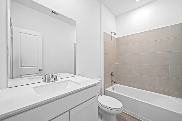 a bathroom with a sink a toilet and a bathtub