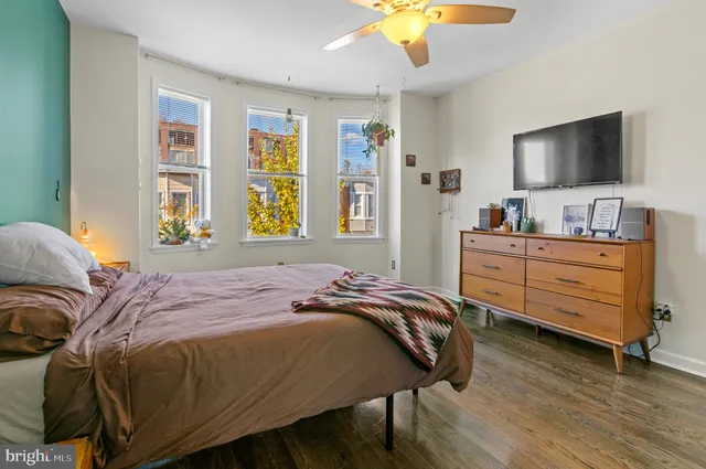 a bedroom with a bed and a flat screen tv