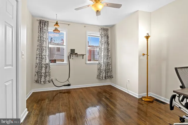 a room with wooden floor and white walls