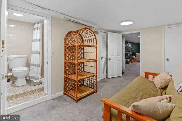 a living room with furniture and a painting on the wall