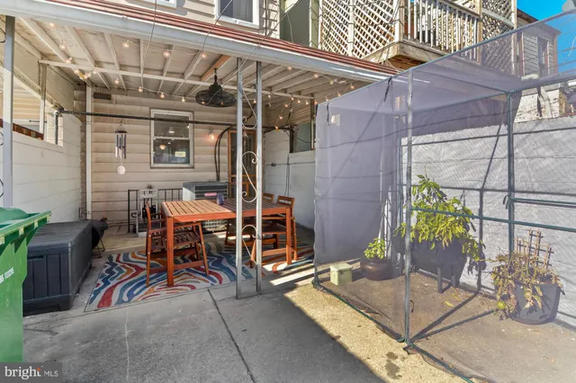 a view of a patio with table and chairs and potted plants
