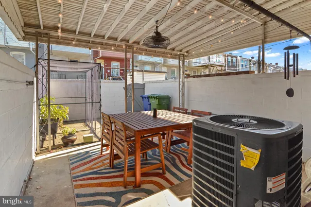 a roof deck with table and chairs