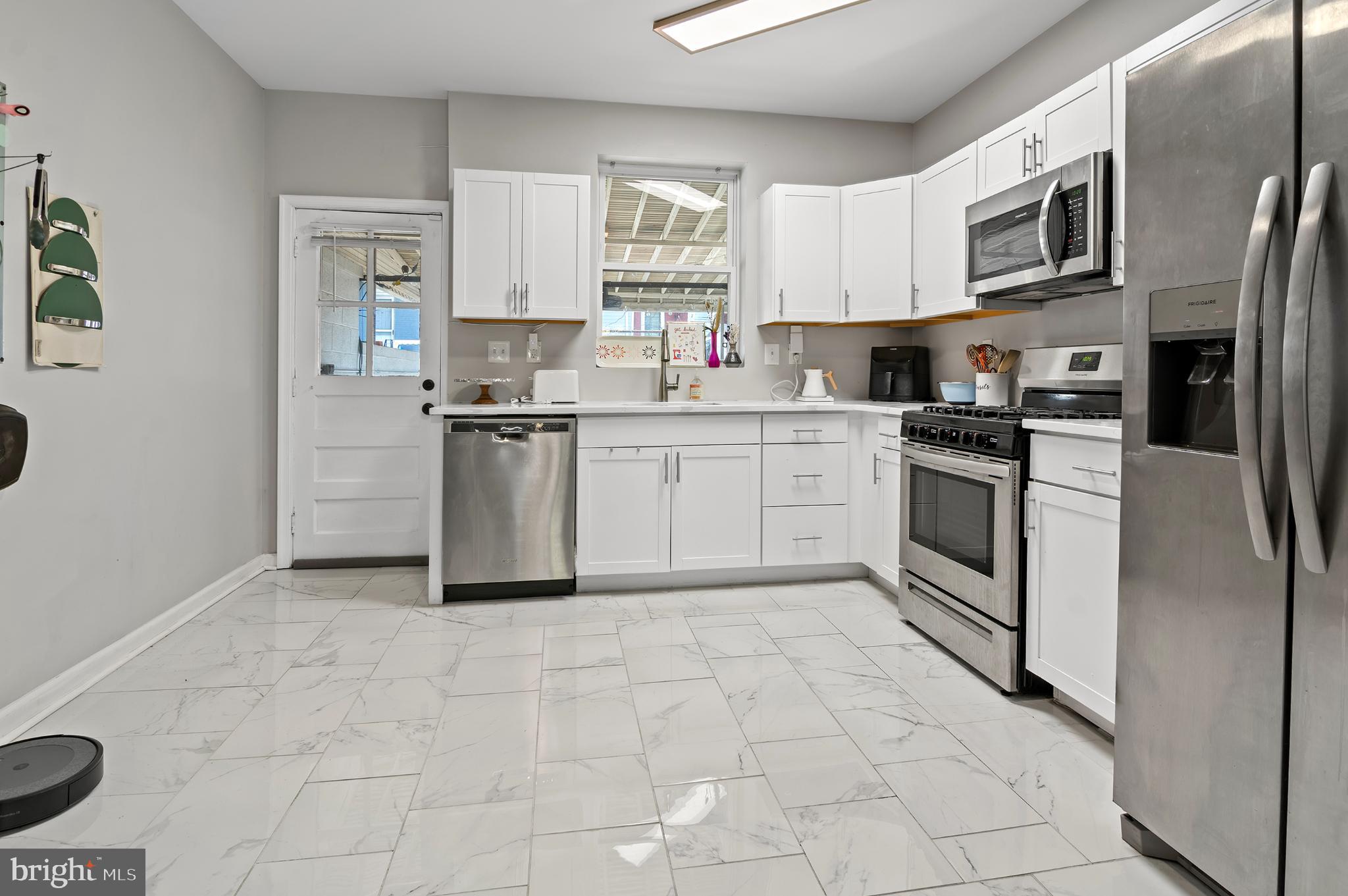 505 South Lehigh Street Baltimore, MD 21224 - Photo 5 of 25 a kitchen with stainless steel appliances granite countertop a stove top oven a sink a refrigerator a microwave and cabinets