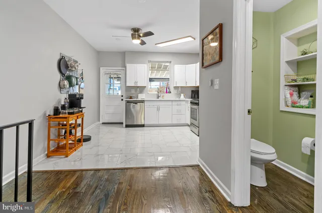 a kitchen with a sink and wooden floor