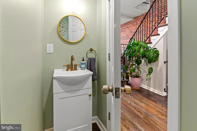 a bathroom with a toilet a sink and a mirror