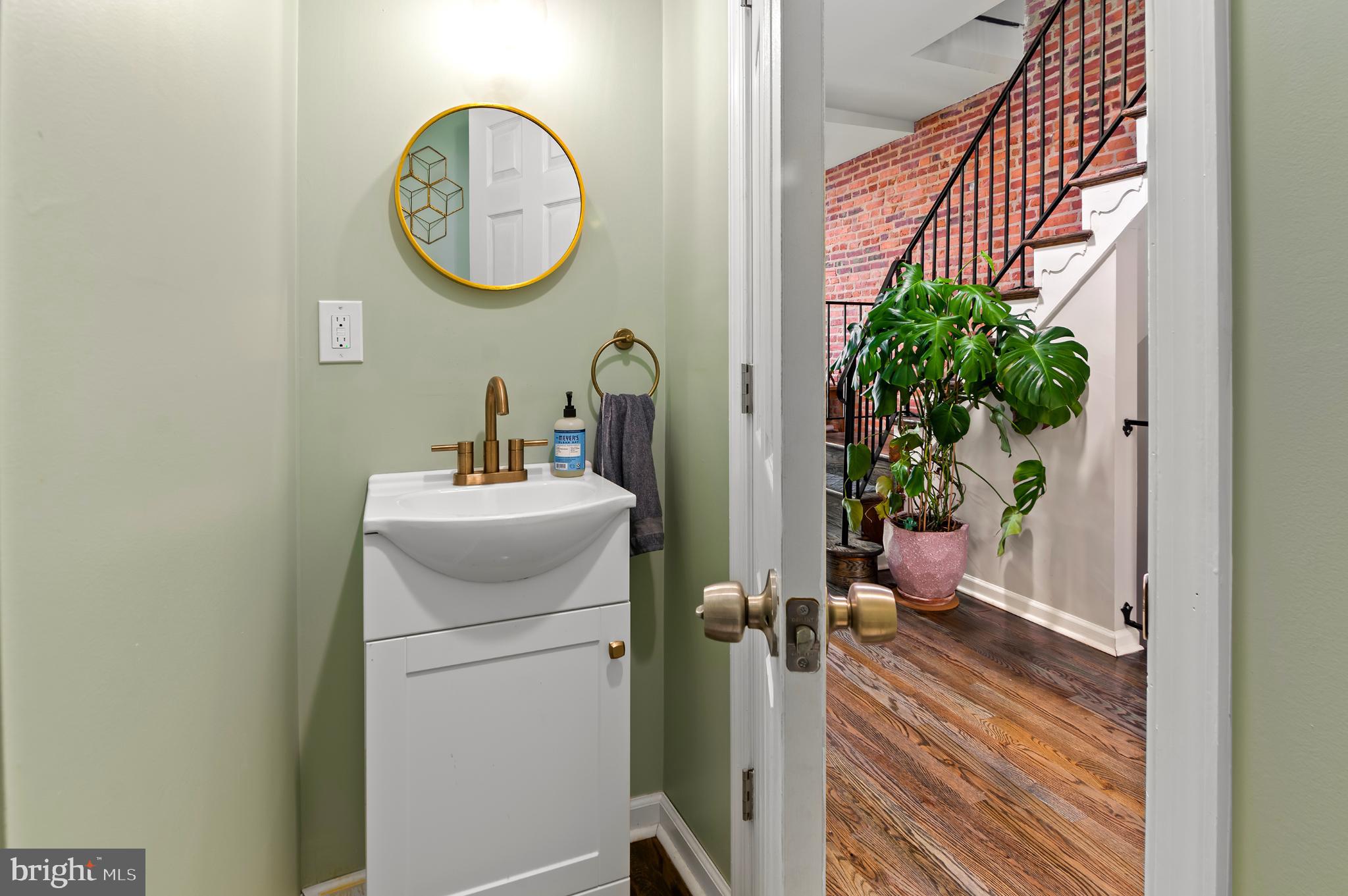 505 South Lehigh Street Baltimore, MD 21224 - Photo 9 of 25 a bathroom with a toilet a sink and a mirror