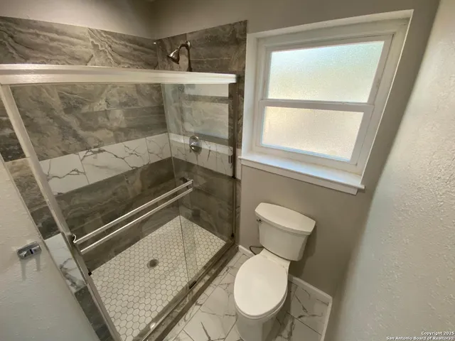a bathroom with a bathtub and shower