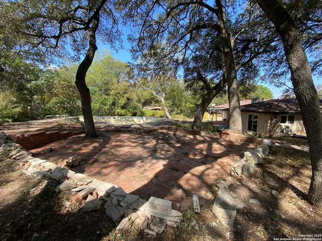 a view of a swimming pool with a yard