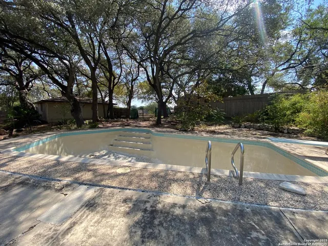 a view of a swimming pool with a patio
