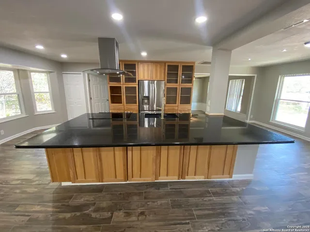 a kitchen with a table chairs and window