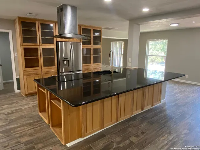 a kitchen with stainless steel appliances granite countertop a sink a counter space and cabinets