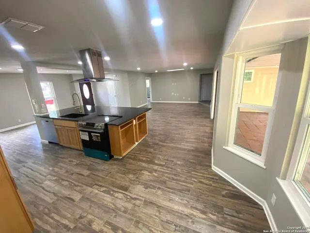 a view of a big room with wooden floor and staircase