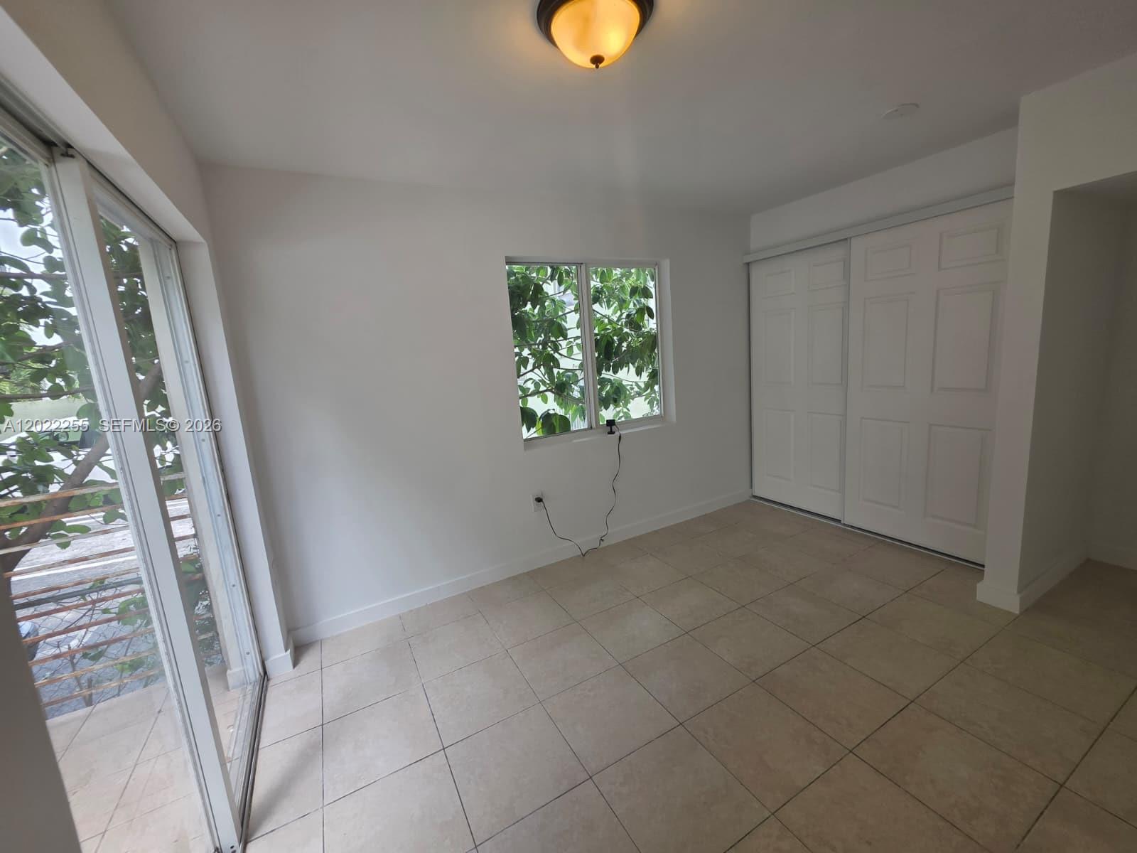 829 Southwest 3rd Street, Unit 831 Miami, FL 33130 - Photo 11 of 21 an empty room with windows