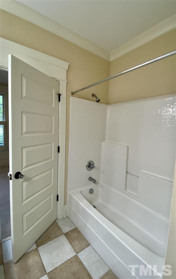 1028 Raleigh, NC 27603 - Photo 11 of 24 a bathroom with a bathtub and a shower