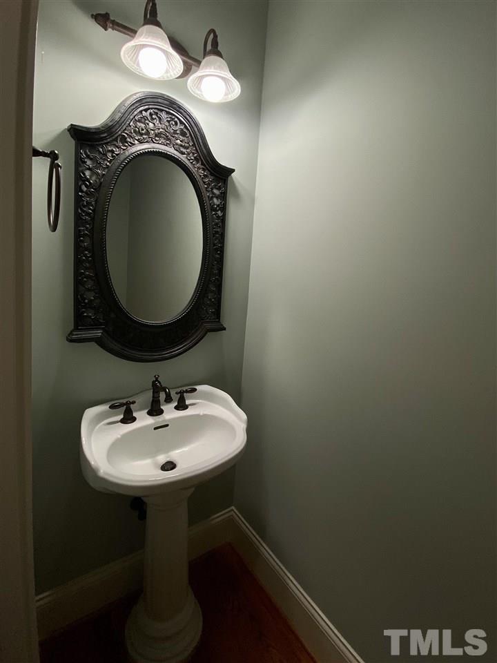 1028 Raleigh, NC 27603 - Photo 12 of 24 a bathroom with a sink and a mirror