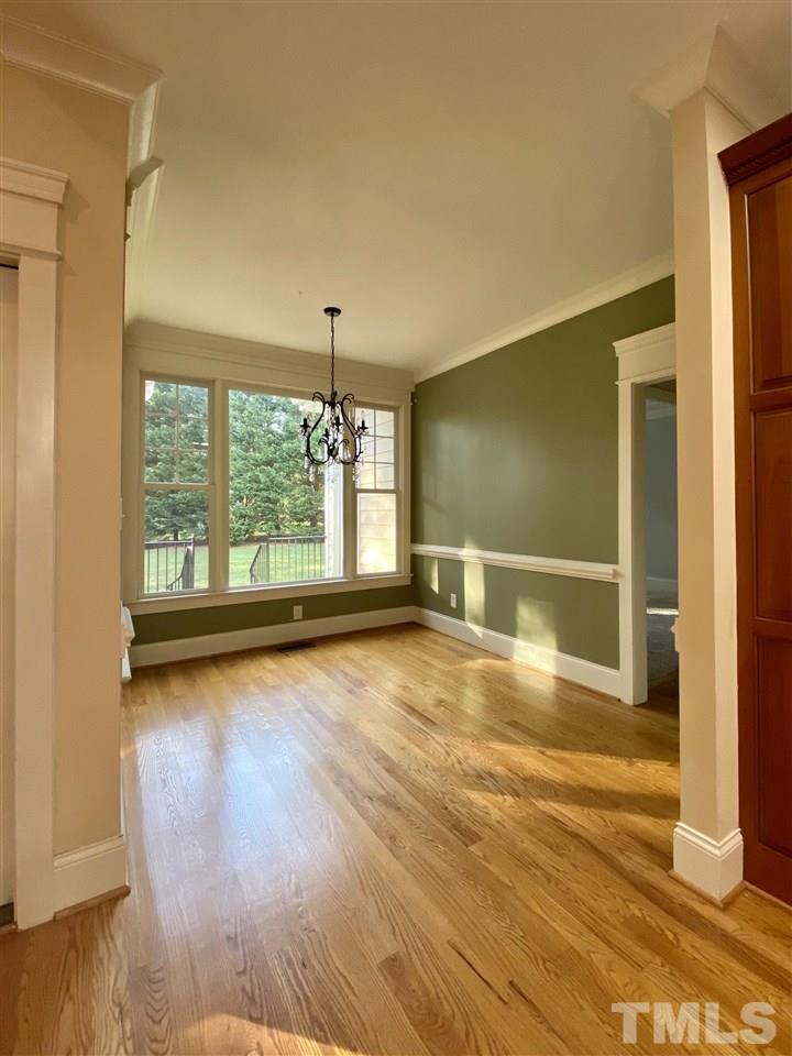 1028 Raleigh, NC 27603 - Photo 13 of 24 a view of an empty room with window and wooden floor