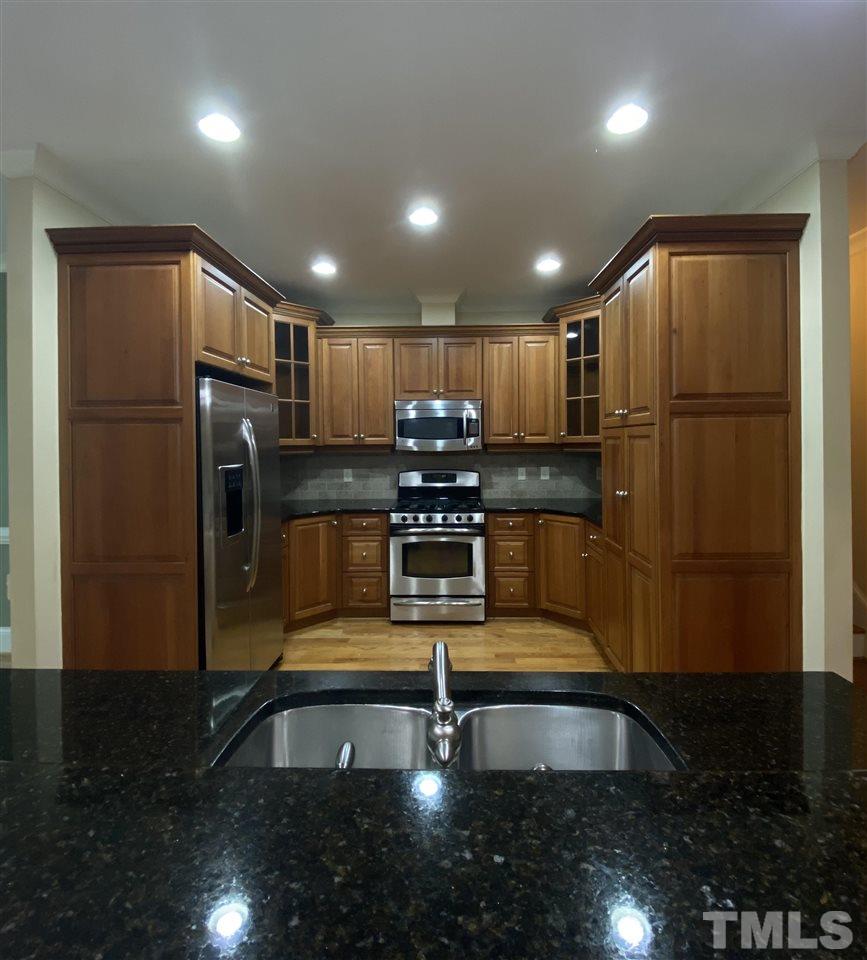 1028 Raleigh, NC 27603 - Photo 14 of 24 a kitchen with stainless steel appliances granite countertop a refrigerator a stove a sink and a oven