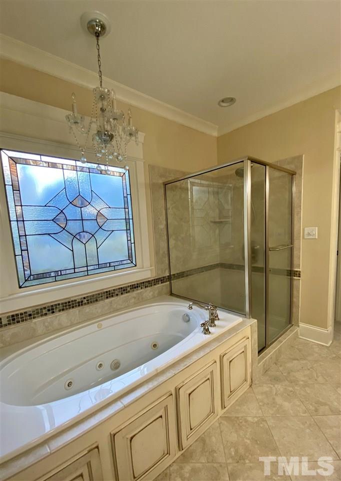 1028 Raleigh, NC 27603 - Photo 21 of 24 a bathroom with a bathtub and a shower
