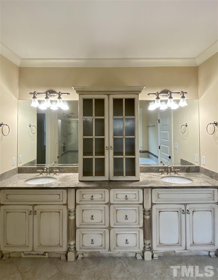 1028 Raleigh, NC 27603 - Photo 22 of 24 a bathroom with a sink vanity and mirror