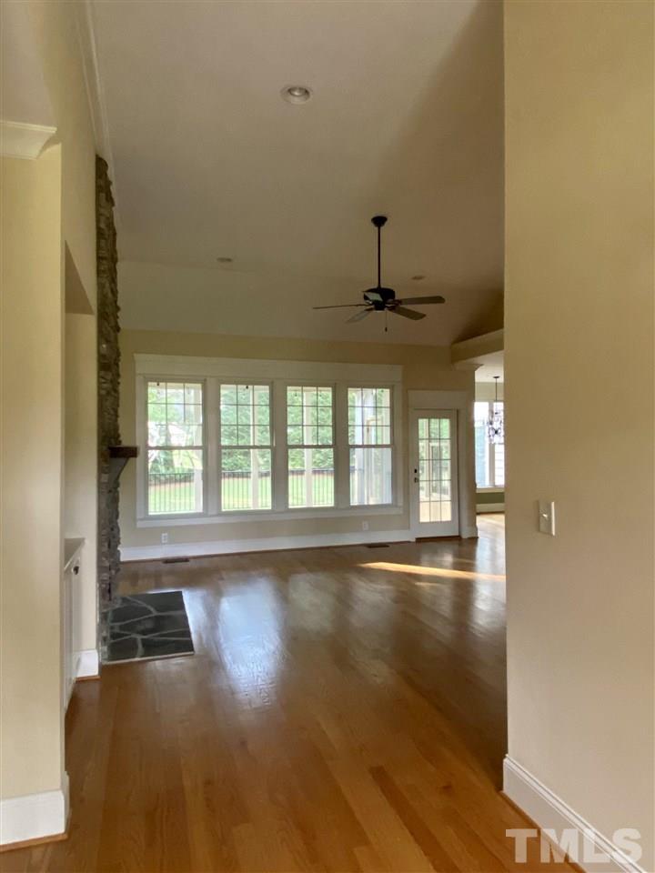 1028 Raleigh, NC 27603 - Photo 4 of 24 a view of an empty room with a window and wooden floor