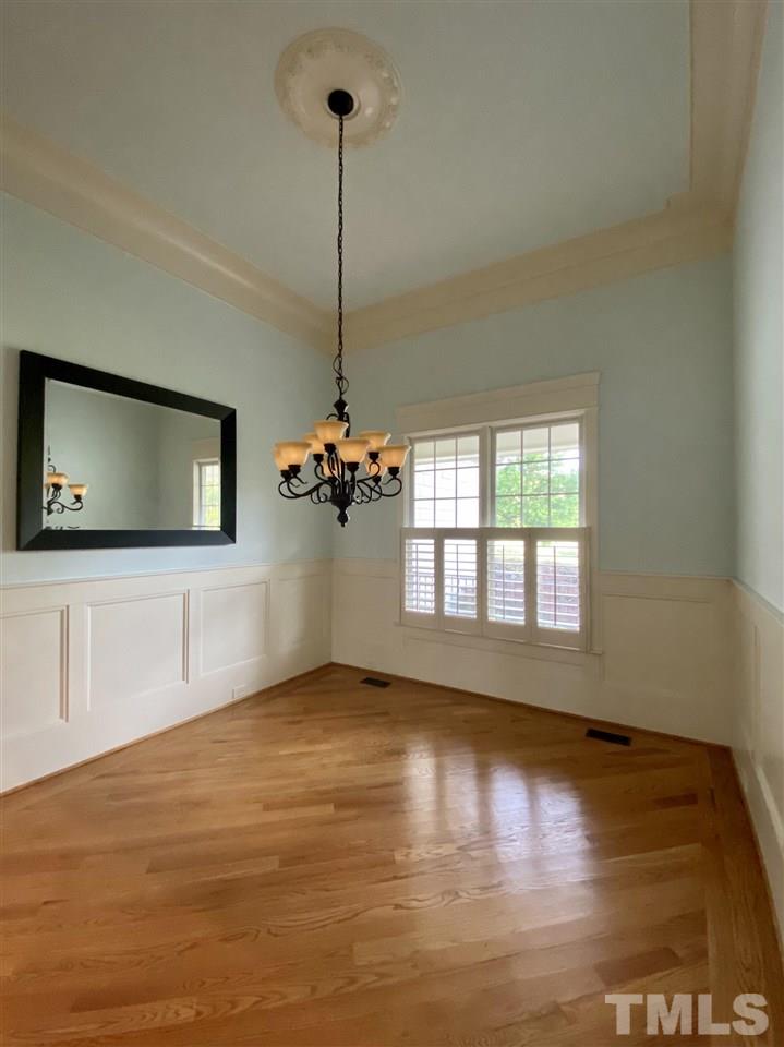 1028 Raleigh, NC 27603 - Photo 5 of 24 a view of an empty room with window and wooden floor