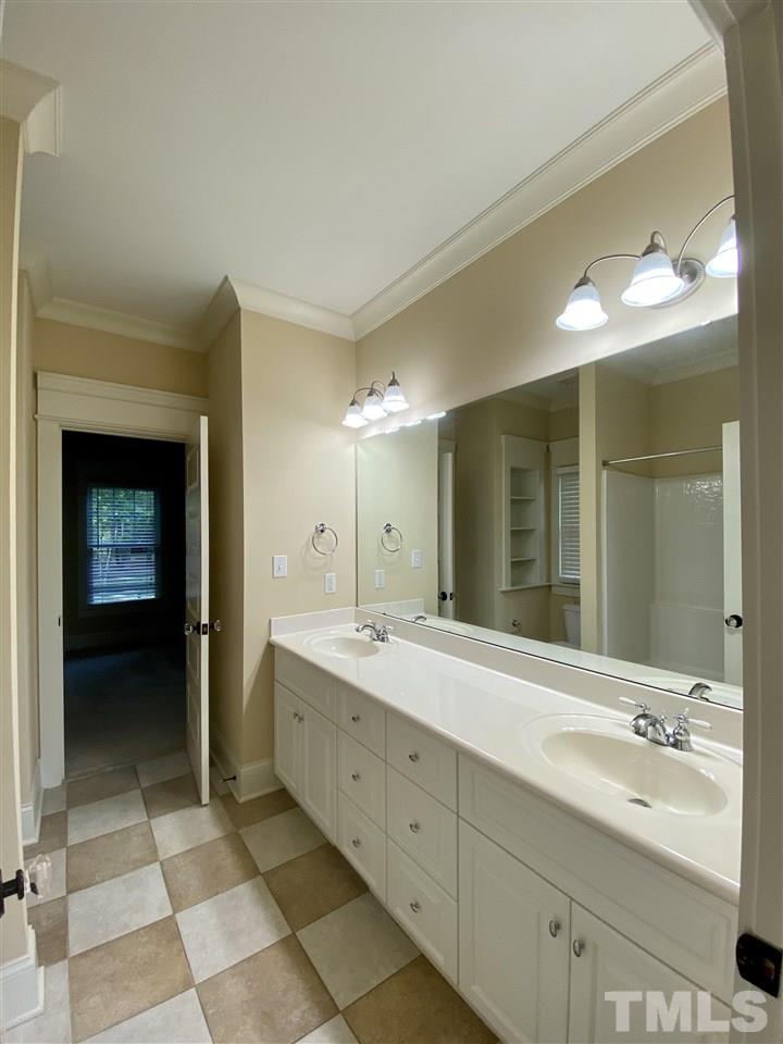 1028 Raleigh, NC 27603 - Photo 10 of 24 a bathroom with a double vanity sink and a mirror