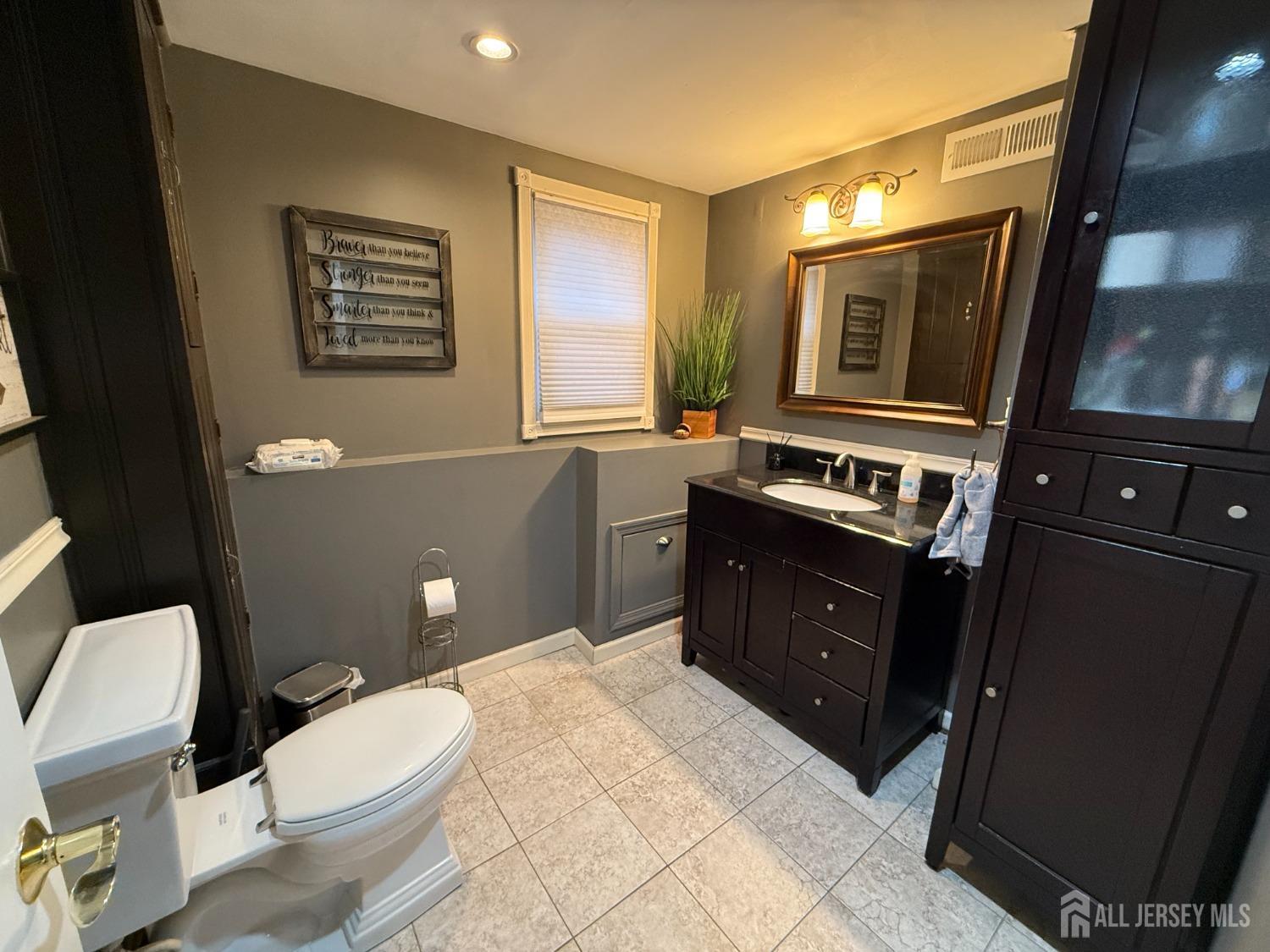 420 Seneca Avenue Middlesex, NJ 08846 - Photo 15 of 25 a bathroom with a toilet a sink and mirror