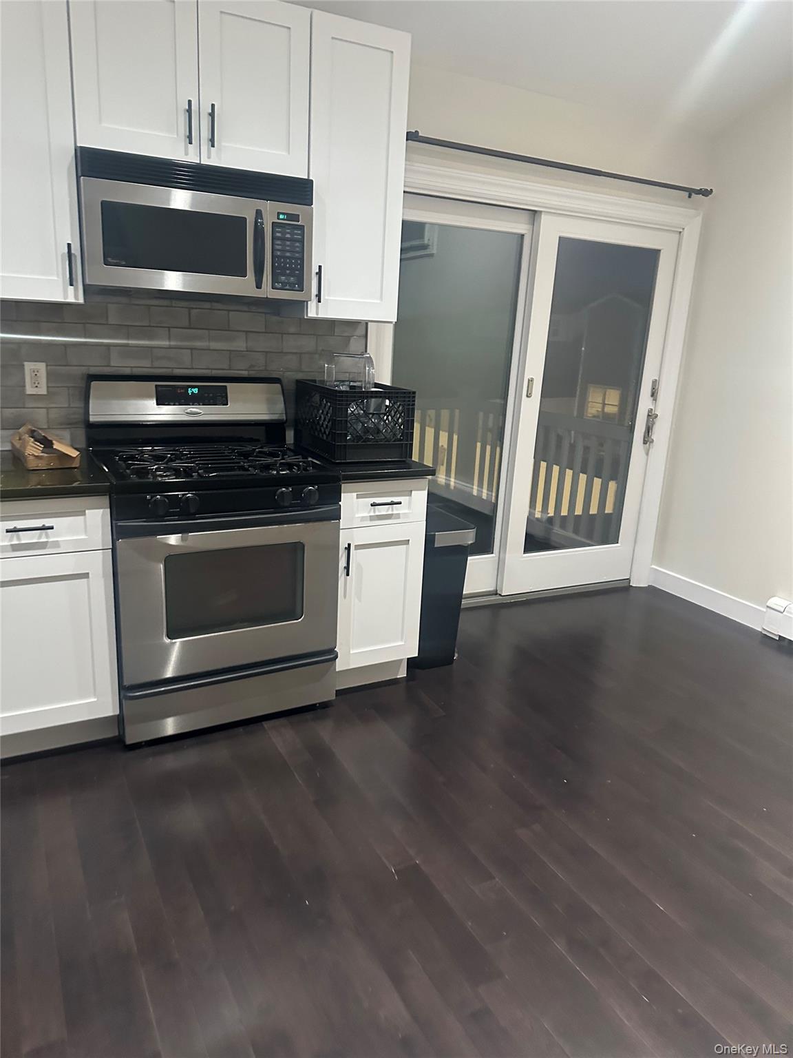 Undisclosed Address West Babylon, NY 11704 - Photo 4 of 8 a kitchen with granite countertop a stove and a microwave