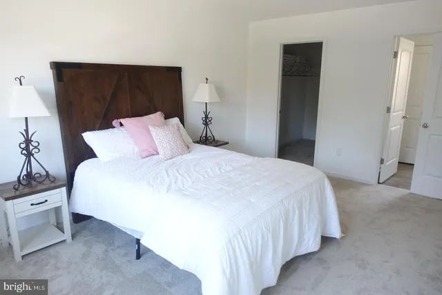 a bedroom with a bed and a night stand