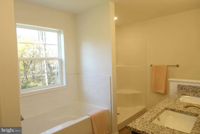 a bathroom with a tub and a sink