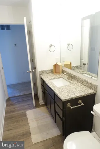 a bathroom with a granite countertop sink and a mirror