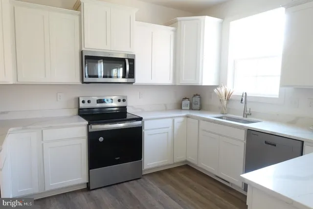 a kitchen with a sink stove and microwave