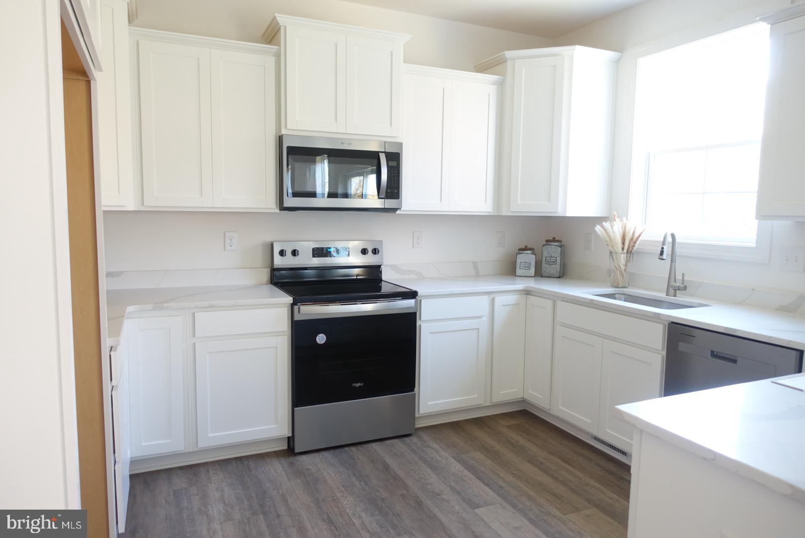 221 Kinneman Road, Unit 28 Abbottstown, PA 17301 - Photo 6 of 26 a kitchen with a sink cabinets and a window
