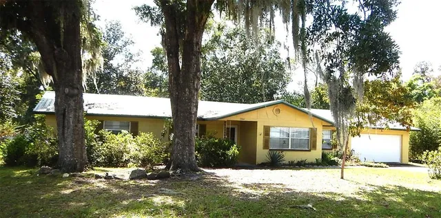a front view of a house with a yard covered in snow