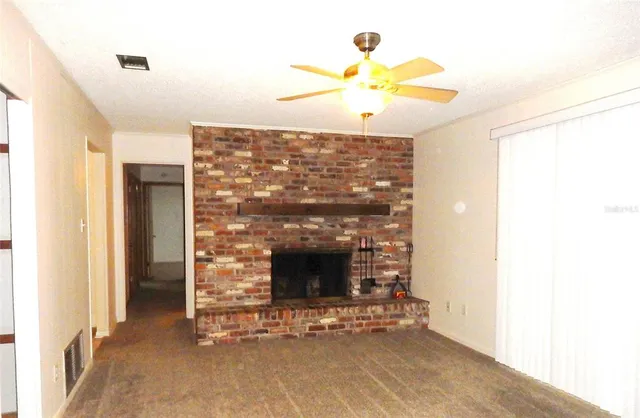 a living room with a fireplace furniture and a chandelier