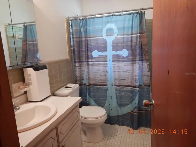 a bathroom with a toilet and shower
