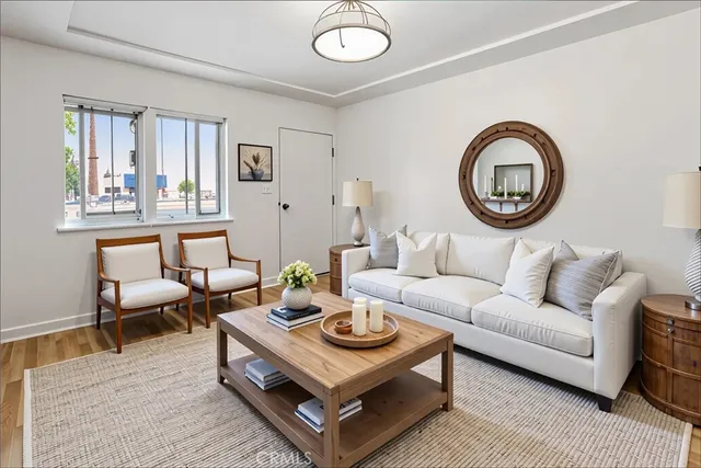 a living room with furniture a rug and a window