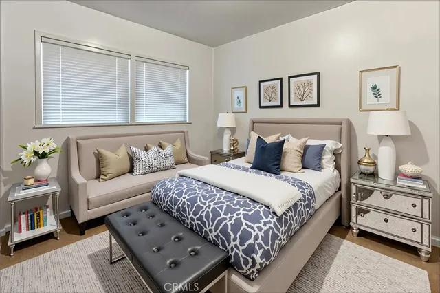 a bedroom with a bed and a couch